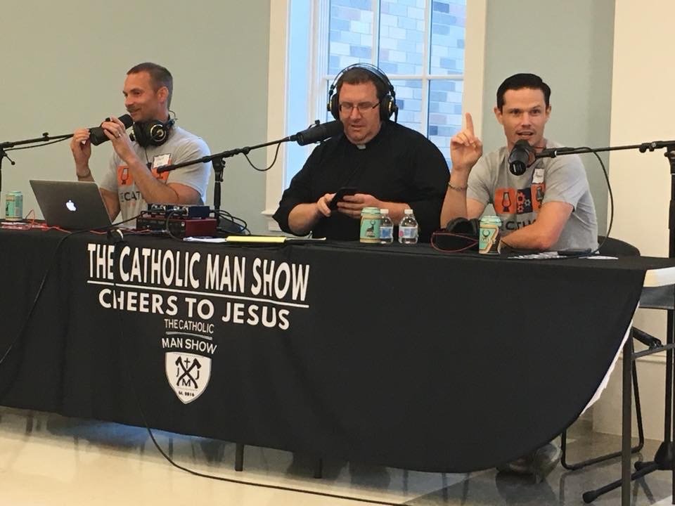 David, Adam, and another speaker engaged in discussion at a conference table.